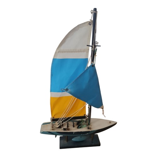 Wood sailboat with green hull - with,